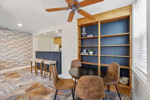 ADU Dining area featuring a brick wall, ceiling fan, recessed lighting, and a baseboard radiator