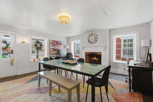 Dining area featuring a desk and a brick fireplace