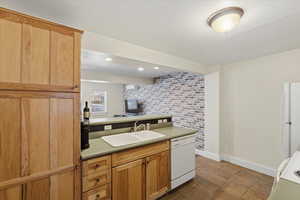 ADU kitchen featuring  white appliances, a peninsula, recessed lighting, and light countertops
