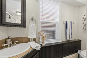Bathroom with a vanity and a tub with a shower.