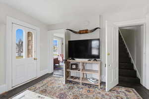 Entrance foyer featuring stairs and wood finished floors