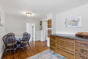 Kitchen featuring hardwood flooring and a small table.