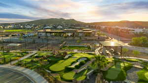 Surrounding community featuring a mountain view, a residential view, and a putting green