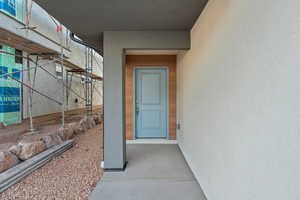 Property entrance featuring stucco siding