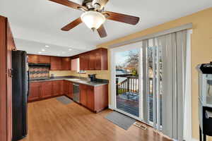 Kitchen with freestanding refrigerator, recessed lighting, a ceiling fan, light wood-type flooring, and dishwasher