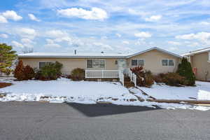 View of front of house featuring a wooden deck