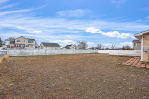 Fenced backyard with a residential view