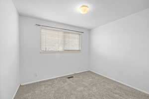 Unfurnished room with baseboards and carpet floors