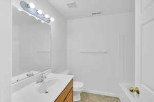 Bathroom with vanity and tub / shower combination