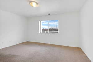 Empty room with light carpet and baseboards