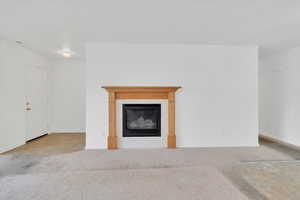 Living room featuring carpet and  fireplace
