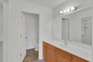 Bathroom with vanity, toilet and set in shower