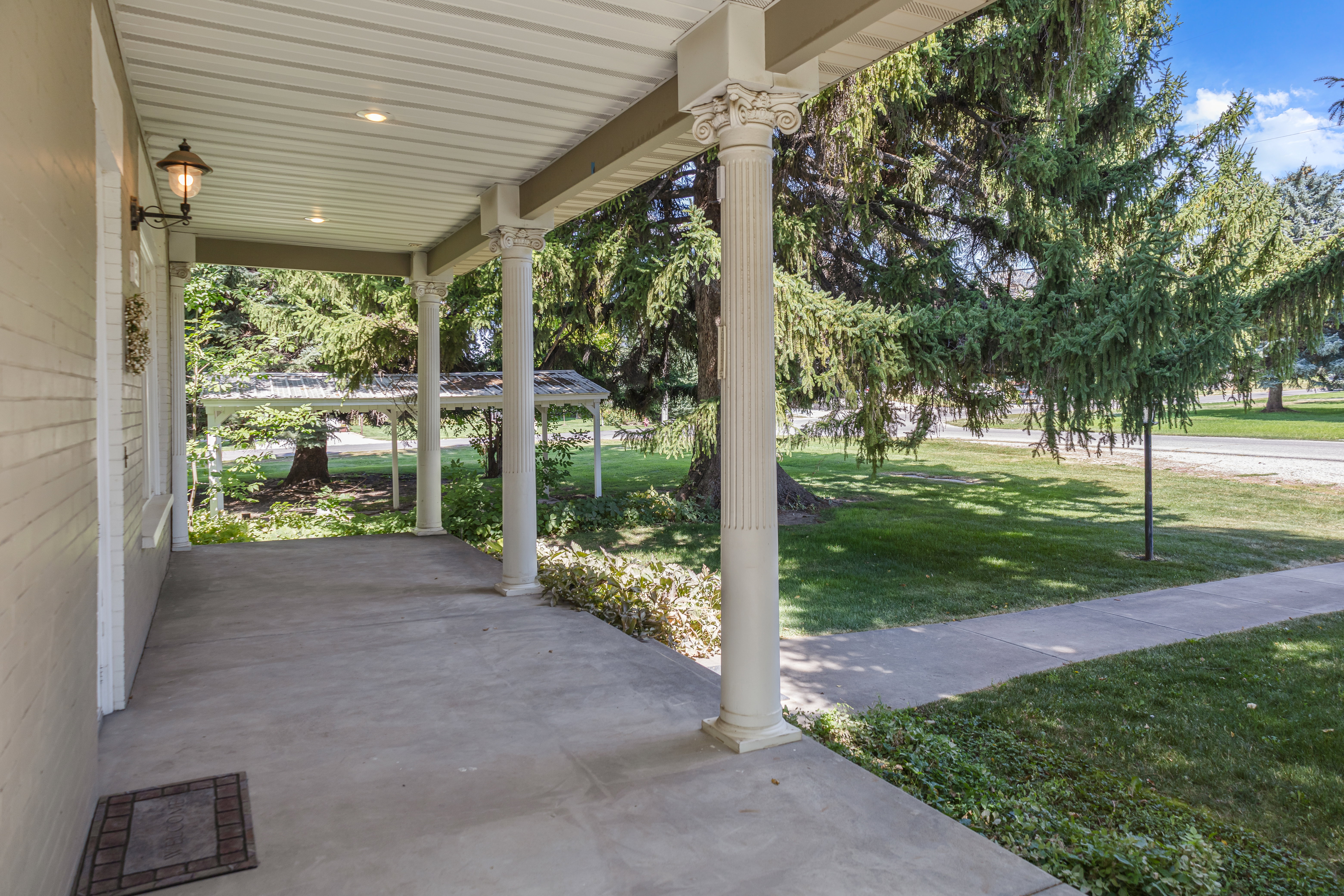 Porch featuring a lawn