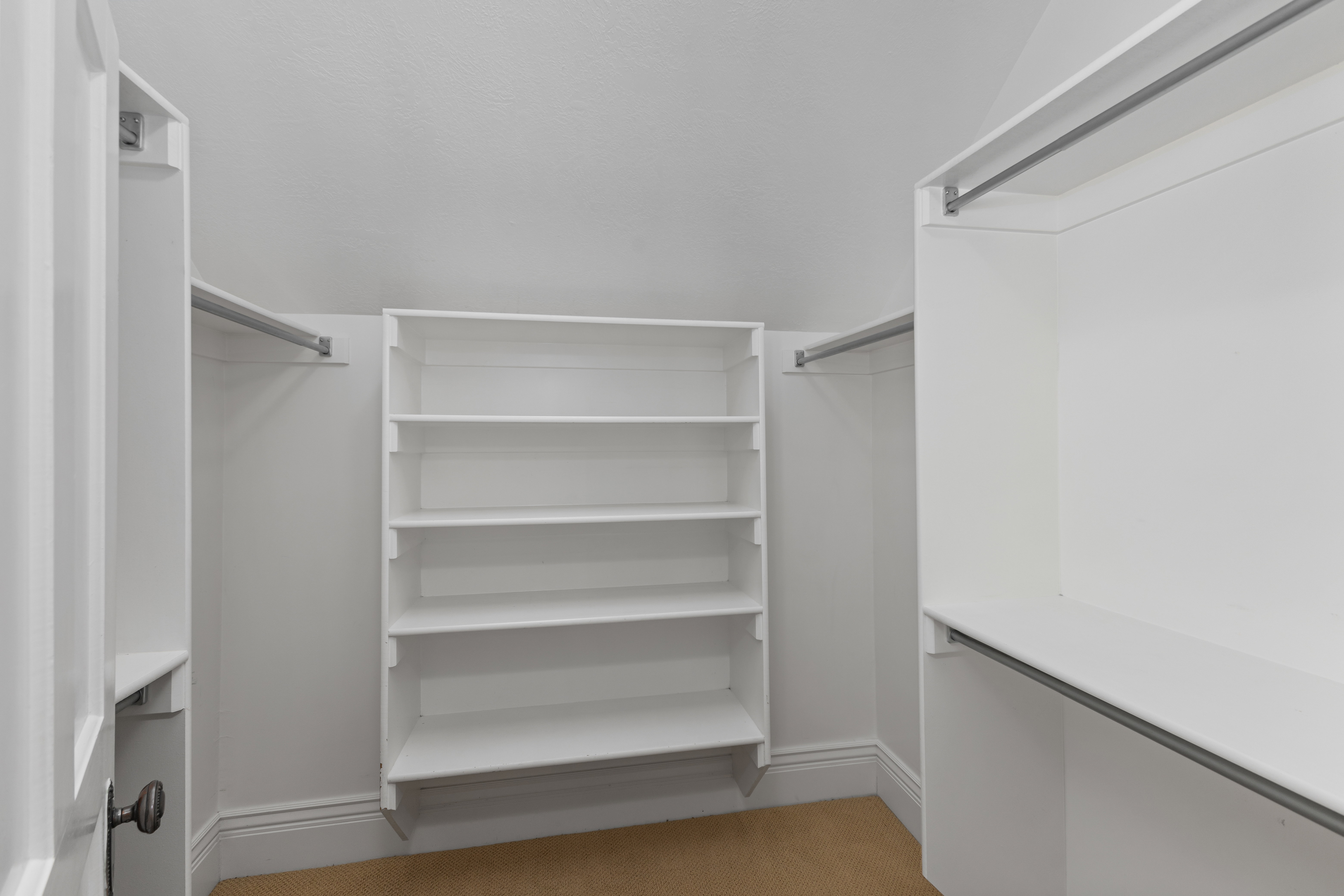 Spacious closet featuring light colored carpet