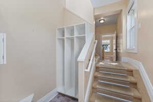 Staircase featuring baseboards