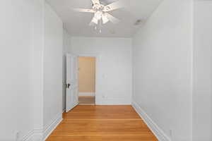 Empty room with light wood-style flooring and a ceiling fan
