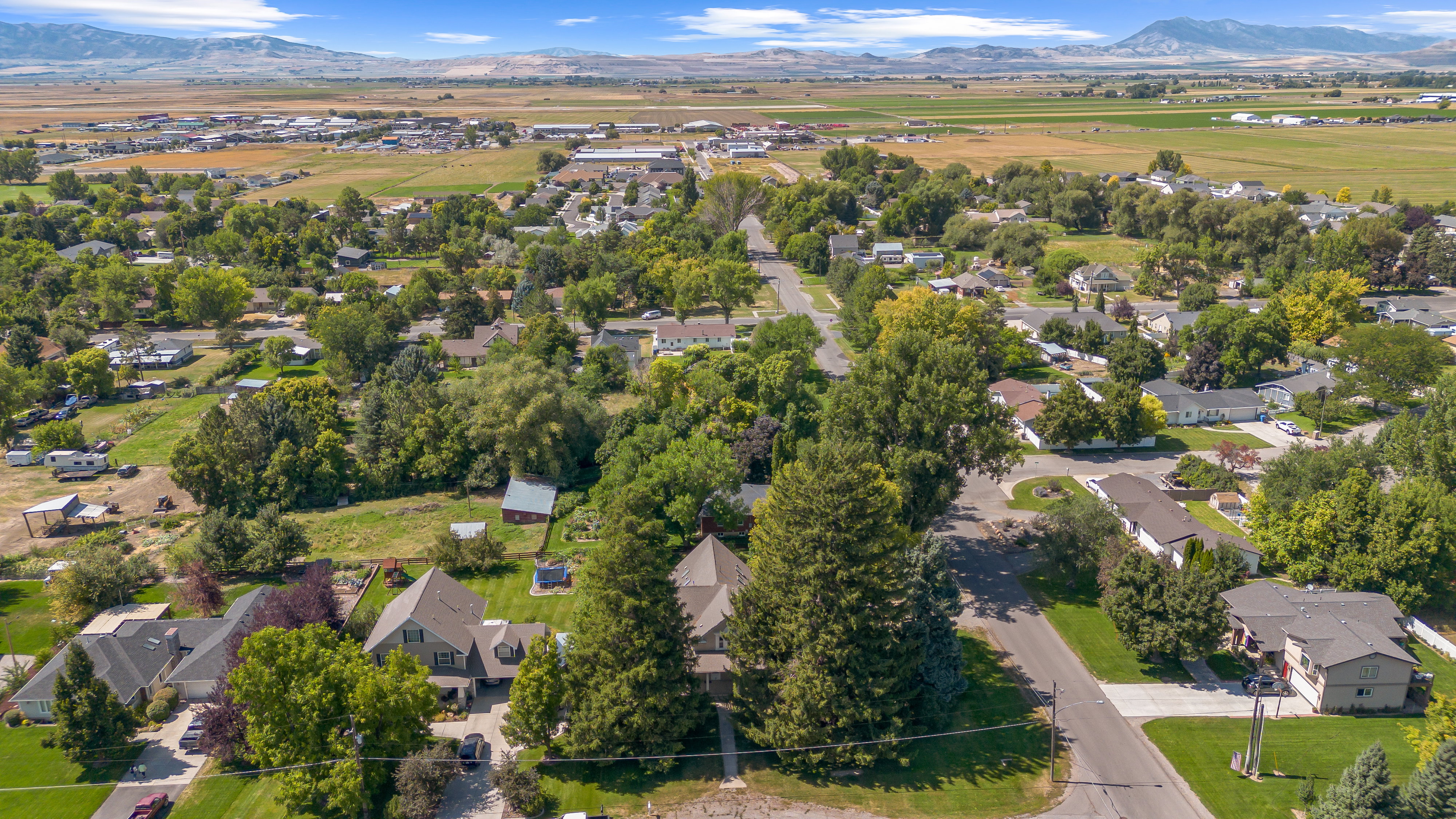 Aerial overview of property's location with nearby suburban area and a mountainous background