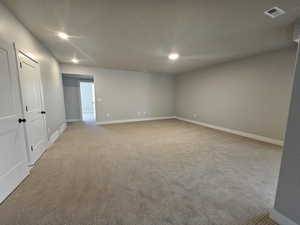 Spare room with light carpet and recessed lighting