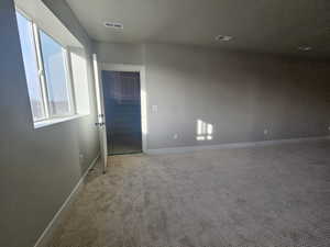 Carpeted empty room with baseboards