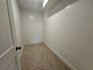 Carpeted empty room featuring baseboards