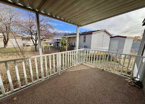 View of patio / terrace featuring a shed and a residential view