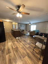 Home office with dark wood-style flooring and a sink