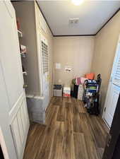 Laundry area featuring dark wood finished floors, hookup for a washing machine, and a heating unit