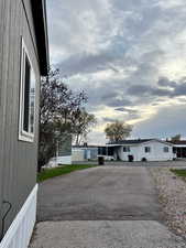 View of front facade with asphalt driveway