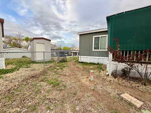 View of yard with a storage shed