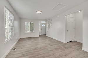 Foyer with light wood-type flooring and stairway