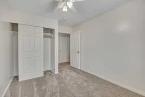 Unfurnished bedroom featuring carpet floors, a closet, and a ceiling fan