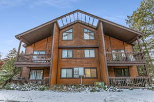 Snow covered house with a balcony