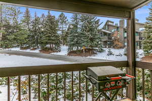 View of snow covered back of property