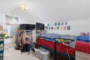 Carpeted bedroom with vaulted ceiling
