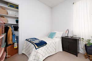 Bedroom with a closet and light colored carpet
