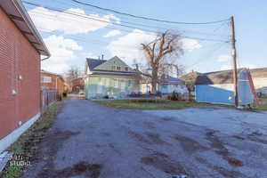 View of front facade featuring a trampoline, an outbuilding, and driveway