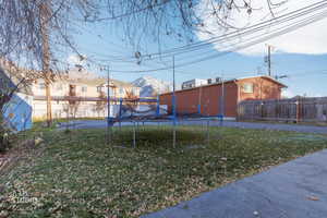 View of yard featuring a trampoline and a mountain view