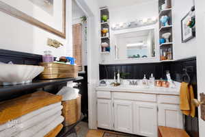 Bathroom featuring vanity and wainscoting