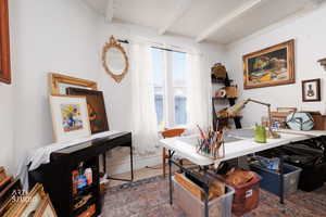 Office space featuring beamed ceiling