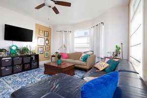 Living room featuring a ceiling fan