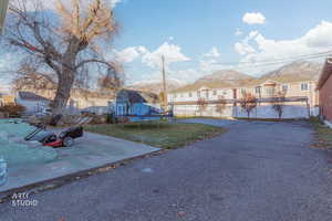 View of yard featuring a residential view, a trampoline, and a patio