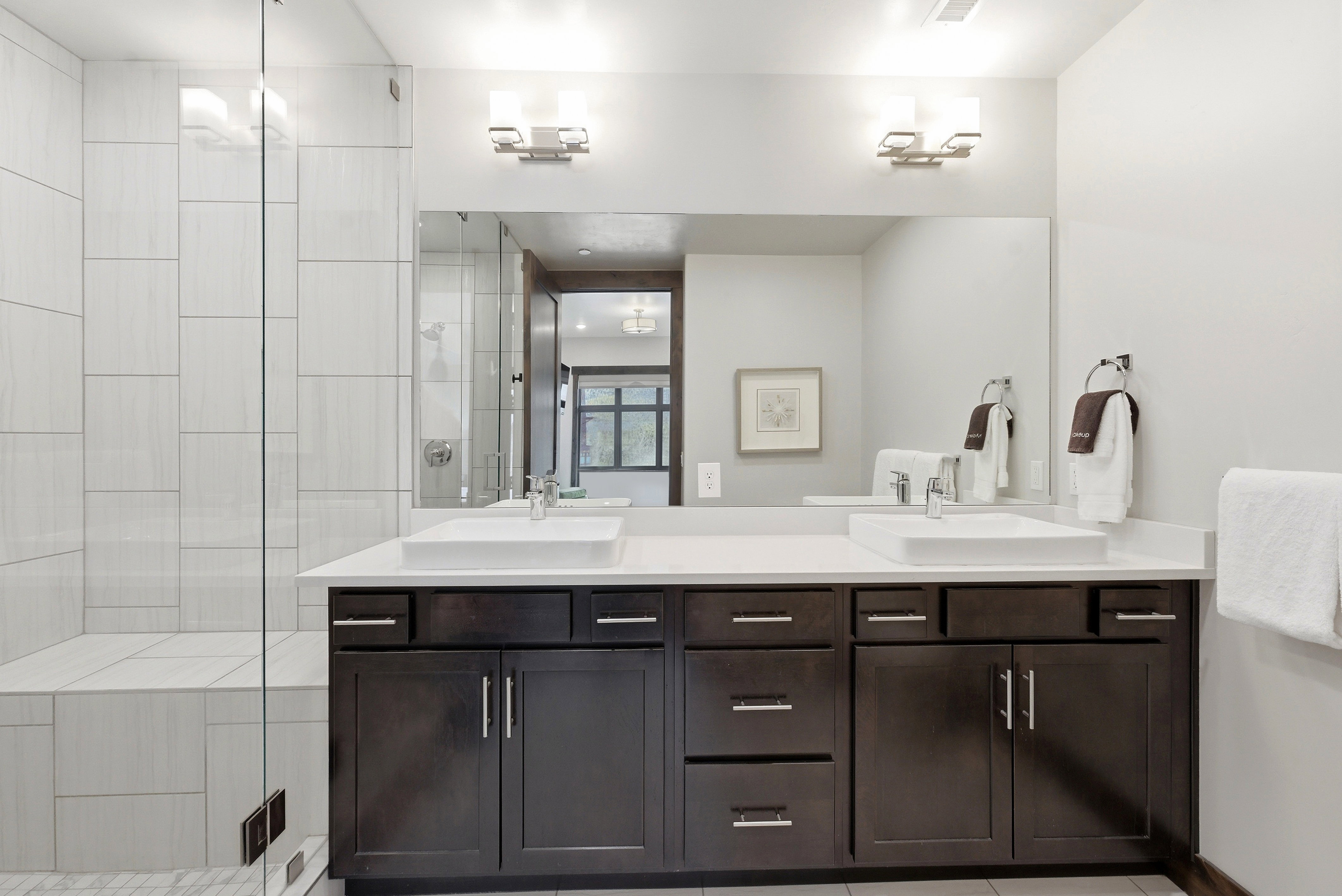 Double vanity with vessel sinks and dark wood-finish cabinetry