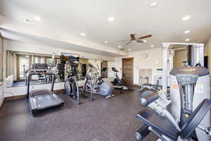 Fitness room featuring rubberized flooring and mirrored walls