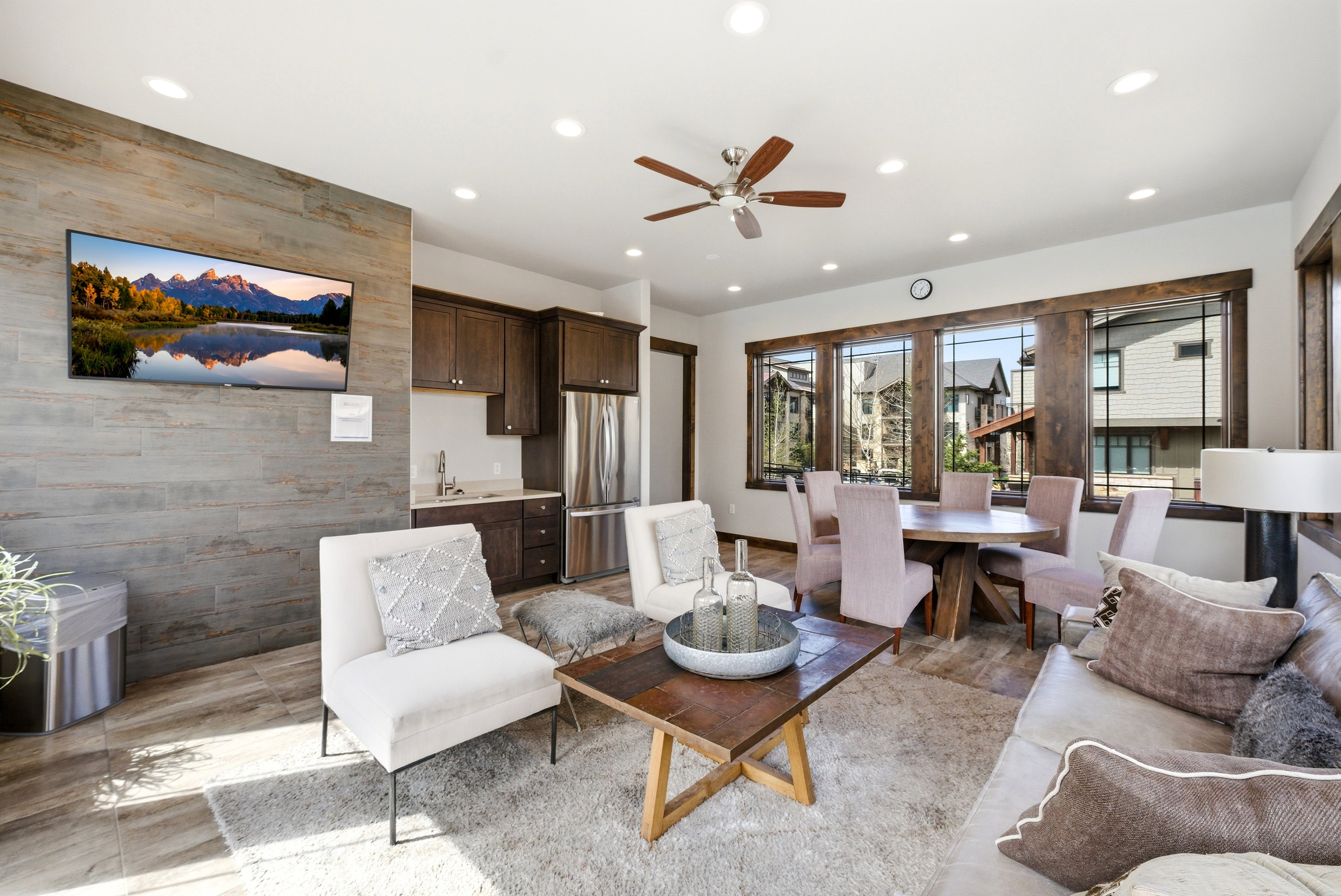Open-concept living space featuring wood-finish flooring, recessed lighting, and a ceiling fan