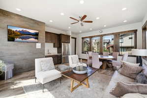 Open-concept living space featuring wood-finish flooring, recessed lighting, and a ceiling fan