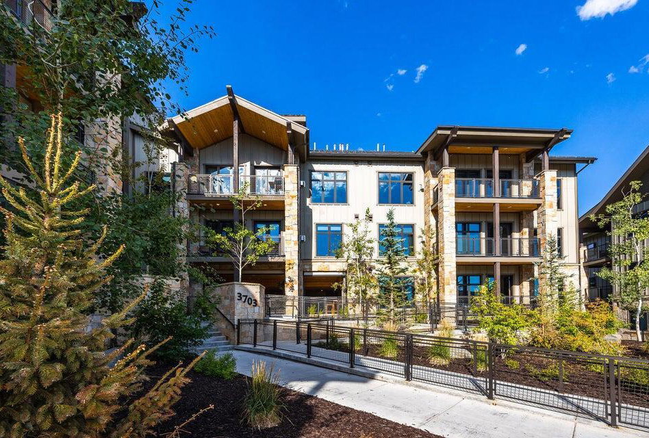 Contemporary multi-story building featuring stone and wood siding