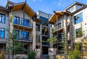 Multi-story building with stone and vertical siding exterior