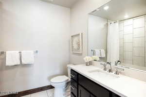 Bathroom with vanity, recessed lighting, curtained shower, and light tile patterned floors