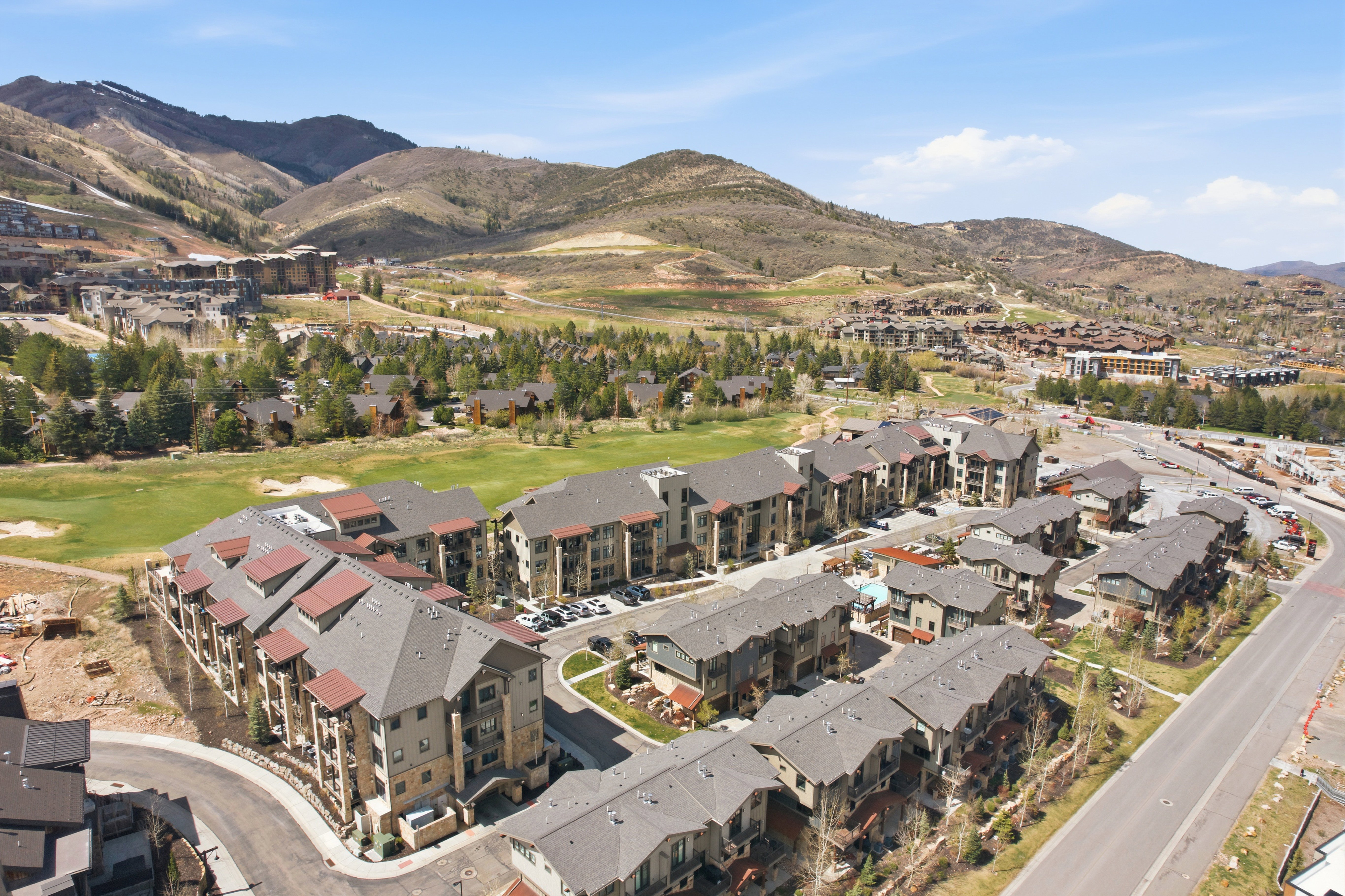 Residential development featuring multi-story buildings with pitched roofs and exterior balconies