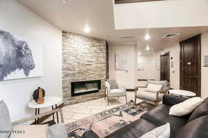Living area with a fireplace, elevator, and recessed lighting